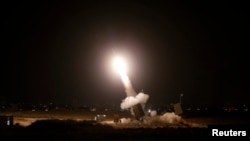 FILE - An Iron Dome launcher fires an interceptor rocket in the southern Israeli city of Ashdod.