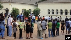 FILE - Voters line up to cast their votes at a polling station, in Maputo, Mozambique, Oct. 15, 2014.