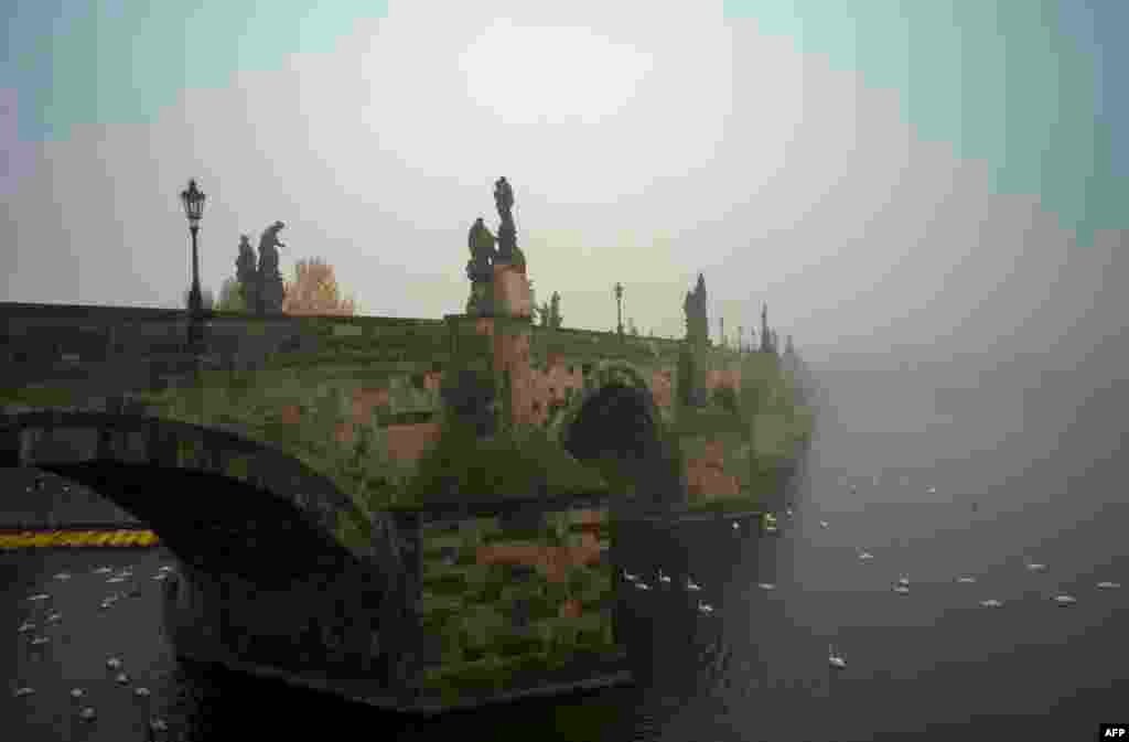 The Charles Bridge is pictured on a foggy morning in Prague.