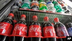 FILE - Sugar-sweetened drinks in a store's refrigerator, Feb. 20, 2013