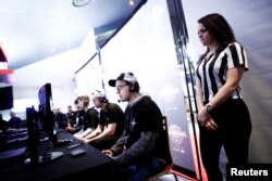 A referee watches over competitors playing "Call of Duty: Infinite Warfare" on the Playstation 4, during the Cineplex WorldGaming Canadian Championship Series, an esports video game tournament, n Toronto, Ontario, March 26, 2017.