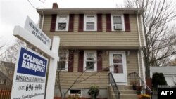 In this Nov. 16, 2011 photo, a real estate sign hangs in front of a home, in Milton, Mass. Existing-home sales improved in October while the number of homes on the market continued to decline, according to the National Association of Realtors(R). (AP Phot