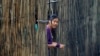 FILE - A refugee who fled Myanmar watches from behind a bamboo wall of a stilt house at Mae La refugee camp, near the Thailand-Myanmar border in Mae Sot district, Tak province, north of Bangkok, on July 21, 2014.