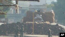 Soldiers are seen at an army checkpoint in Hula, near Homs, Syria, November 4, 2011.