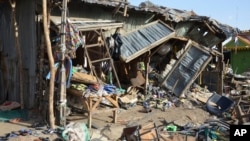 FILE- A teenage girl touched off explosives strapped to her body at a market in Maiduguri, Nigeria, leaving this debris, June 22, 2015