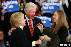 Democratic U.S. presidential candidate Hillary Clinton is accompanied by her daughter Chelsea Clinton (R) and her husband, former U.S. President Bill Clinton, as she speaks to supporters at her final 2016 New Hampshire presidential primary night rally.