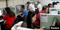 Call center agents work overnight daily to cater to United States clients in Manila's Makati financial district, Feb. 6, 2012.