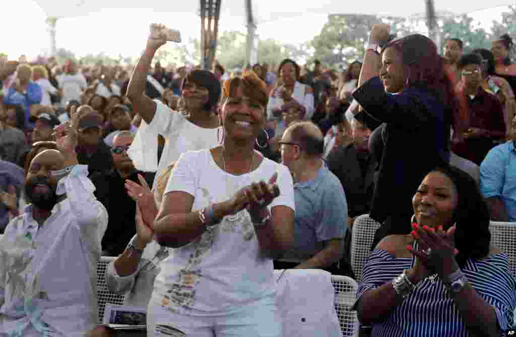 Fans clap and dance as they attend a tribute concert to Aretha Franklin at Chene Park, Aug. 30, 2018, in Detroit. 