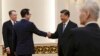 U.S. Treasury Secretary Steven Mnuchin, second from left, shakes hands with Chinese President Xi Jinping as U.S. Trade Representative Robert Lighthizer, left, and Chinese Vice Premier Liu He, right, look on before their meeting at the Great Hall of the Pe