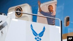 President Barack Obama waves as he arrives on Air Force One, Dec. 16, 2016, in Honolulu, Hawaii, for the annual family vacation on the island of Oahu.