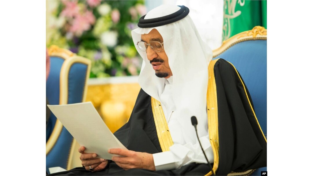 In this photo provided by the Saudi Press Agency, Saudi King Salman delivers his first major policy speech since assuming the throne in the al-Yamama palace, Riyadh, Saudi Arabia, March 10, 2015.