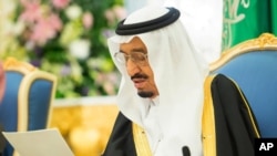 FILE - In this photo provided by the Saudi Press Agency, Saudi King Salman delivers his first major policy speech since assuming the throne in the al-Yamama palace, Riyadh, Saudi Arabia, March 10, 2015.