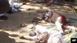 Bodies lies on the ground following a bomb explosion in Yola, Nigeria, Friday, Oct. 23, 2015. Two suicide bombers struck at city mosques in northeast Nigeria on Friday, killing over 40 people and wounding more than 100, an official and witnesses said. (AP/Ibrahim Abdulaziz)