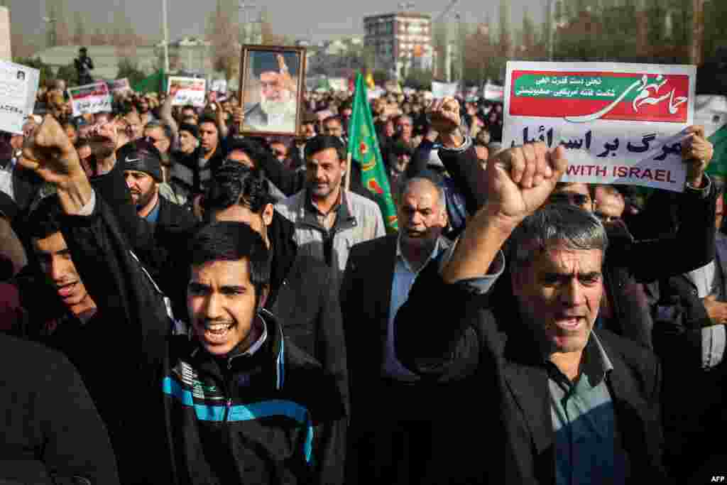 Iranians chant slogans as they march in support of the government near the Imam Khomeini grand mosque in the capital Tehran, Iran, Dec. 30, 2017.