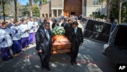 Pallbearers carry Pat Conroy's casket out of St. Peter's Catholic Parish after his funeral mass in Beaufort, South Carolina, March 8, 2016.