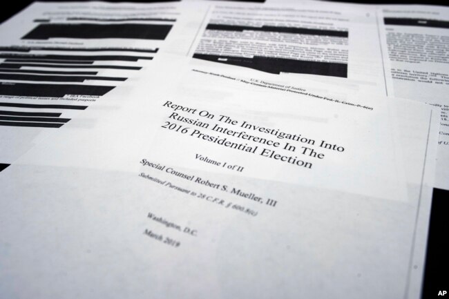 FILE - Four pages of special counsel Robert Mueller's report are shown on the witness table in the House Intelligence Committee hearing room on Capitol Hill, in Washington, April 18, 2019.