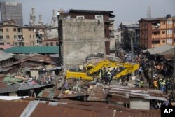 Emergency workers attend the scene of a collapsed building in Lagos, Nigeria, March 14, 2019.