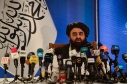 FILE - The Taliban's foreign minister, Amir Khan Muttaqi, speaks to the media in Kabul, Afghanistan, Sept. 14, 2021.