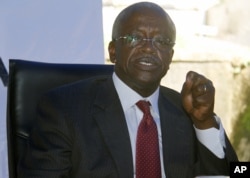 FILE - Uganda opposition presidential candidate Patrick Amama Mbabazi address a press conference at his offices in capital, Kampala, Dec. 21, 2015.