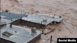 In this image shared on social media and verified by VOA Persian, a flash flood submerges buildings in western Iran’s Lorestan province, April 1, 2019. 