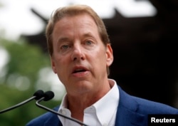 FILE - Executive Chairman of Ford Motor Co., Bill Ford Jr. addresses the public outside the Historic Ford Estate, once the home of his great-grandparents Henry and Clara Ford, during a celebration in honor of what would have been the 150th birthday of Henry Ford.