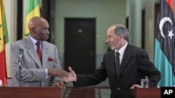Senegal's President Abdoulaye Wade, left, shakes hands with National Transitional Council chairman Mustafa Abdul-Jalil after their joint press conference in Benghazi, Libya, June 9, 2011