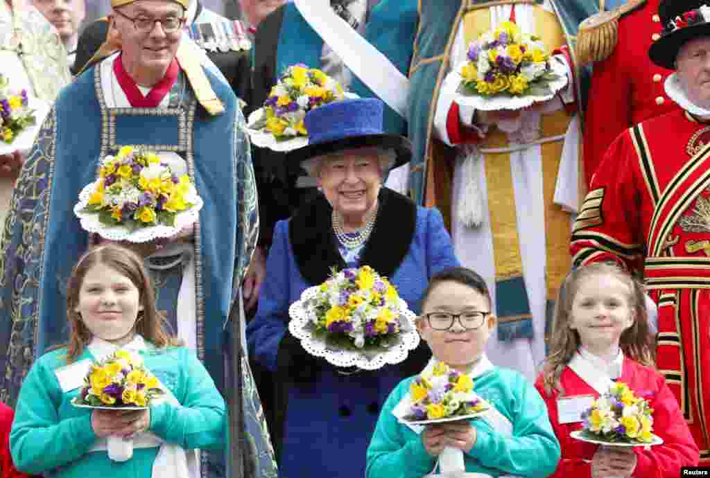 Britain&#39;s Queen Elizabeth holds a bouquet after attending the Royal Maundy service at St George&#39;s Chapel in Windsor.