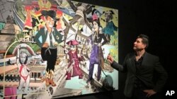 Border artist Claudio Dicochea explains one of the paintings in his 'Acid Baroque' exhibit on display at the Scottsdale Museum of Contemporary Art in Scottsdale, Arizona, through May 20, 2018.