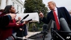 CNN journalist Abby Phillip asks President Donald Trump a question as he speaks with reporters before departing for France on the South Lawn of the White House, Nov. 9, 2018, in Washington. 