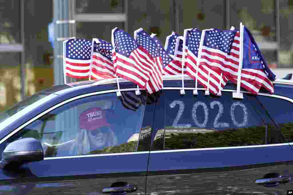 A protester joins a caravan outside of City Hall in Los Angeles. Demonstrators, supporting President Donald Trump, are gathering in various parts of Southern California as Congress debates to affirm President-elect Joe Biden&#39;s&nbsp;electoral victory.