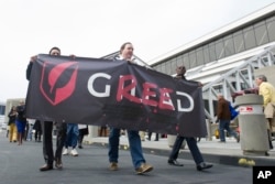 FILE - Protesters demonstrate against high prices of pharmaceutical company Gilead in March 2013 in Atlanta.