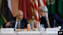 U.S. Secretary of State John Kerry talks with Arab League Secretary General Nabil Elaraby before the start of a meeting with representatives of the Arab League at the United States Embassy in Paris, Sunday, Sept. 8, 2013. 