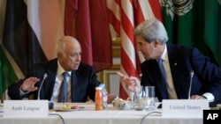 U.S. Secretary of State John Kerry talks with Arab League Secretary General Nabil Elaraby before the start of a meeting with representatives of the Arab League at the United States Embassy in Paris, Sunday, Sept. 8, 2013.