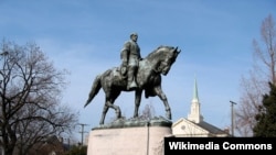 FILE - A statue of Confederate General Robert E. Lee is seen in a park in Charlottesville, Va. The national debate on the meaning of monuments in growing.