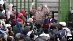 An immigration official addresses Zimbabweans outside an immigration office in downtown Johannesburg, South Africa, December 15, 2010, as they attempt to become legal.