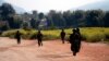 FILE - Myanmar army soldiers carrying weapons patrol on a road as part of operations against ethnic rebels, in Kokang, northeastern Shan State, more than 800 kilometers (500 miles) northeast of Yangon, Myanmar.