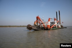 FILE - A dredging machine is seen near the island of Bhasan Char, in the Bay of Bengal, Bangladesh. Feb. 14, 2018.