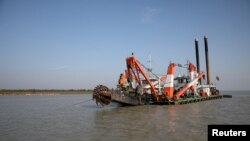FILE - A dredging machine is seen near the island of Bhasan Char, in the Bay of Bengal, Bangladesh. Feb. 14, 2018. 