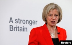FILE - Britain's Home Secretary Theresa May speaks at a news conference in London, March 23, 2015.
