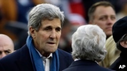 U.S. Secretary of State John Kerry, left, speaks to New England Patriots owner Robert Kraft before the Patriots and the Denver Broncos play in Foxborough, Mass., Nov. 2, 2014.