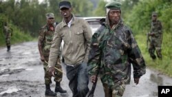 Congolese M23 rebel soldiers are seen on the road to Rushura, some 25 kilometers north of Goma, Nov. 22, 2012. 