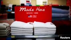 FILE - U.S.-manufactured apparel is featured on a shelf at a Walmart store in Rogers, Arkansas, June 6, 2013.