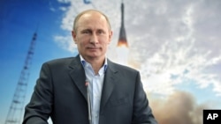 Russian President Vladimir Putin listens during a live video link with the International Space Station, April 12, 2013. 