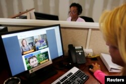 FILE - Specialists help callers and potential customers find health insurance through Obamacare at a customer call center in Rhode Island.