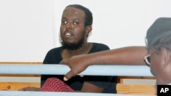 FILE - Hassan Hanafi Haji sits inside Mogadishu's military court during a hearing on the killings of Somali journalists, in Mogadishu, Somalia, March, 3, 2016. 