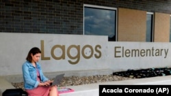 First-year teacher Cindy Hipps sits outside of Lagos Elementary School, at Manor Independent School District campus east of Austin, Texas