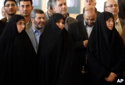 FILE - Then-Iranian Health Minister Marzieh Vahid Dastjerdi, center, stands with lawmakers during a press briefing in Tehran, Iran, Sept. 3, 2009.