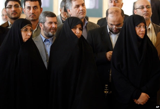 FILE - Then-Iranian Health Minister Marzieh Vahid Dastjerdi, center, stands with lawmakers during a press briefing in Tehran, Iran, Sept. 3, 2009.