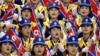 FILE - North Korean women cheer their men's basketball team during a 2002 game at the 14th Asian Games.