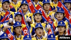 FILE - North Korean women cheer their men's basketball team during a 2002 game at the 14th Asian Games.